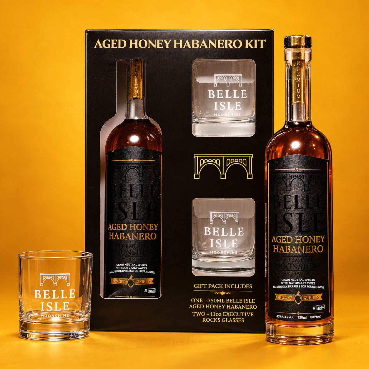 Belle Isle Aged Honey Habanero Kit gift box with bottle and etched rocks glass on a gold background